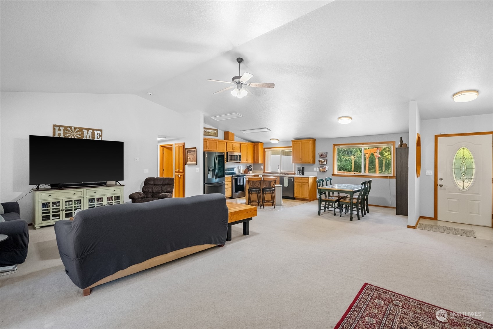 5520 133rd Avenue Southwest Rochester, WA 98579 - Photo 12 of 40 a living room with furniture and a flat screen tv