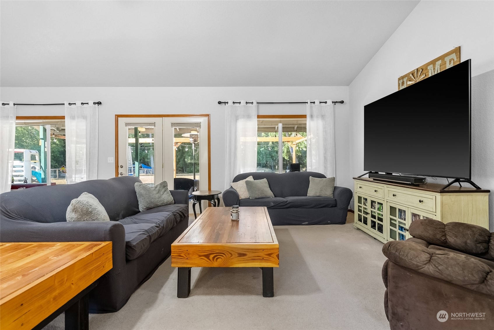 5520 133rd Avenue Southwest Rochester, WA 98579 - Photo 15 of 40 a living room with furniture and a flat screen tv
