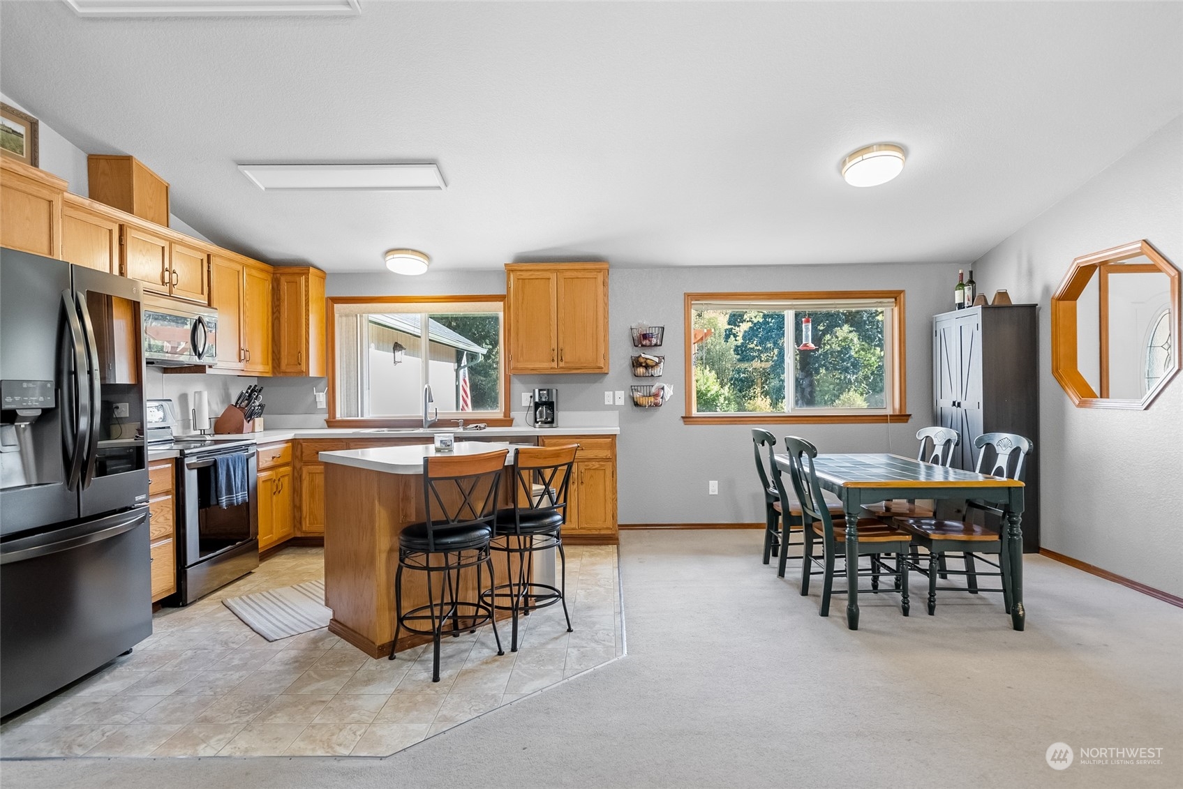 5520 133rd Avenue Southwest Rochester, WA 98579 - Photo 17 of 40 a dining room with a stove a sink a dining table and chairs