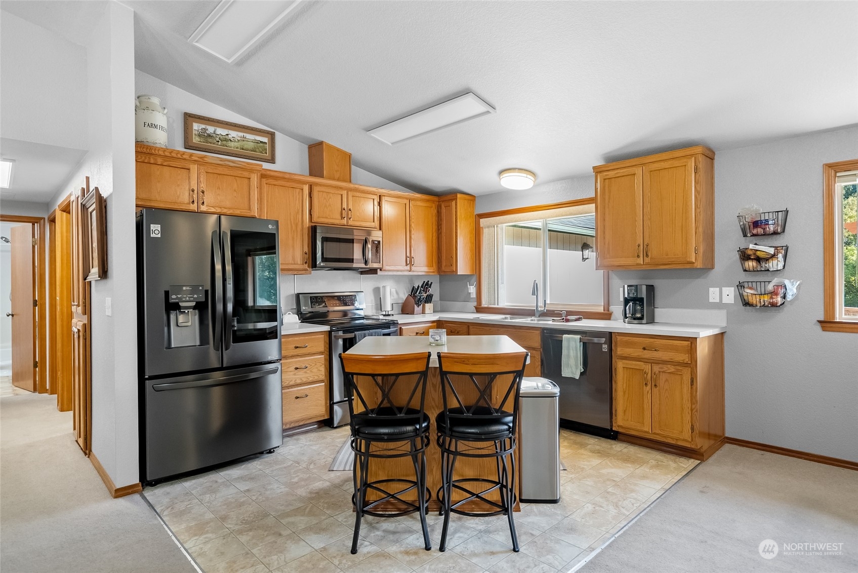 5520 133rd Avenue Southwest Rochester, WA 98579 - Photo 18 of 40 a kitchen with stainless steel appliances granite countertop a dining table and chairs