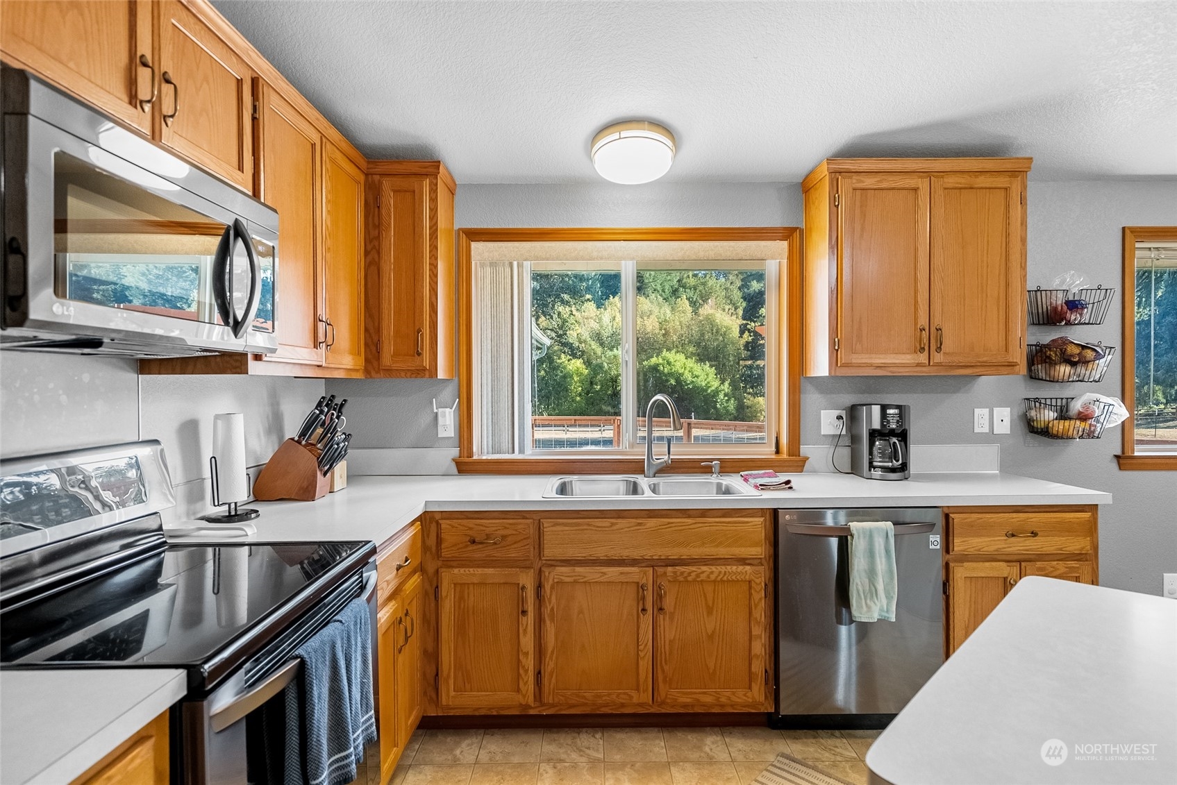 5520 133rd Avenue Southwest Rochester, WA 98579 - Photo 19 of 40 a kitchen with stainless steel appliances granite countertop a stove a sink and a microwave