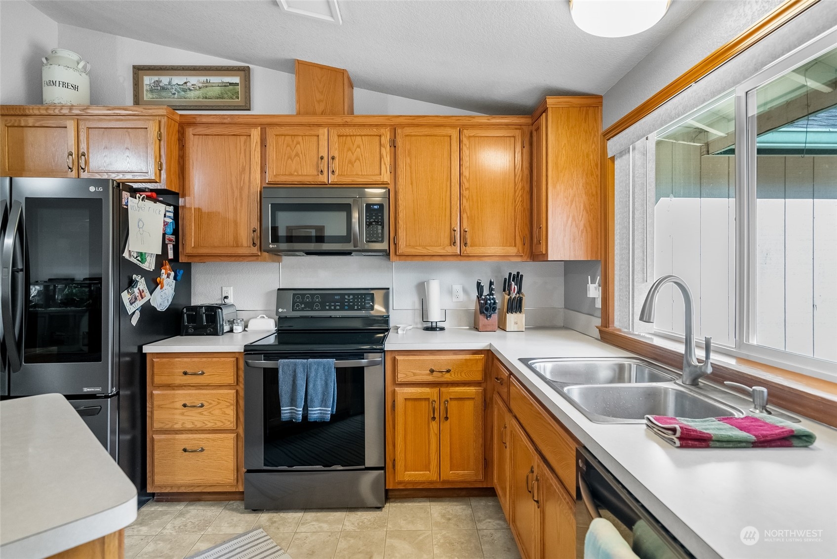 5520 133rd Avenue Southwest Rochester, WA 98579 - Photo 20 of 40 a kitchen with stainless steel appliances granite countertop a sink stove and refrigerator