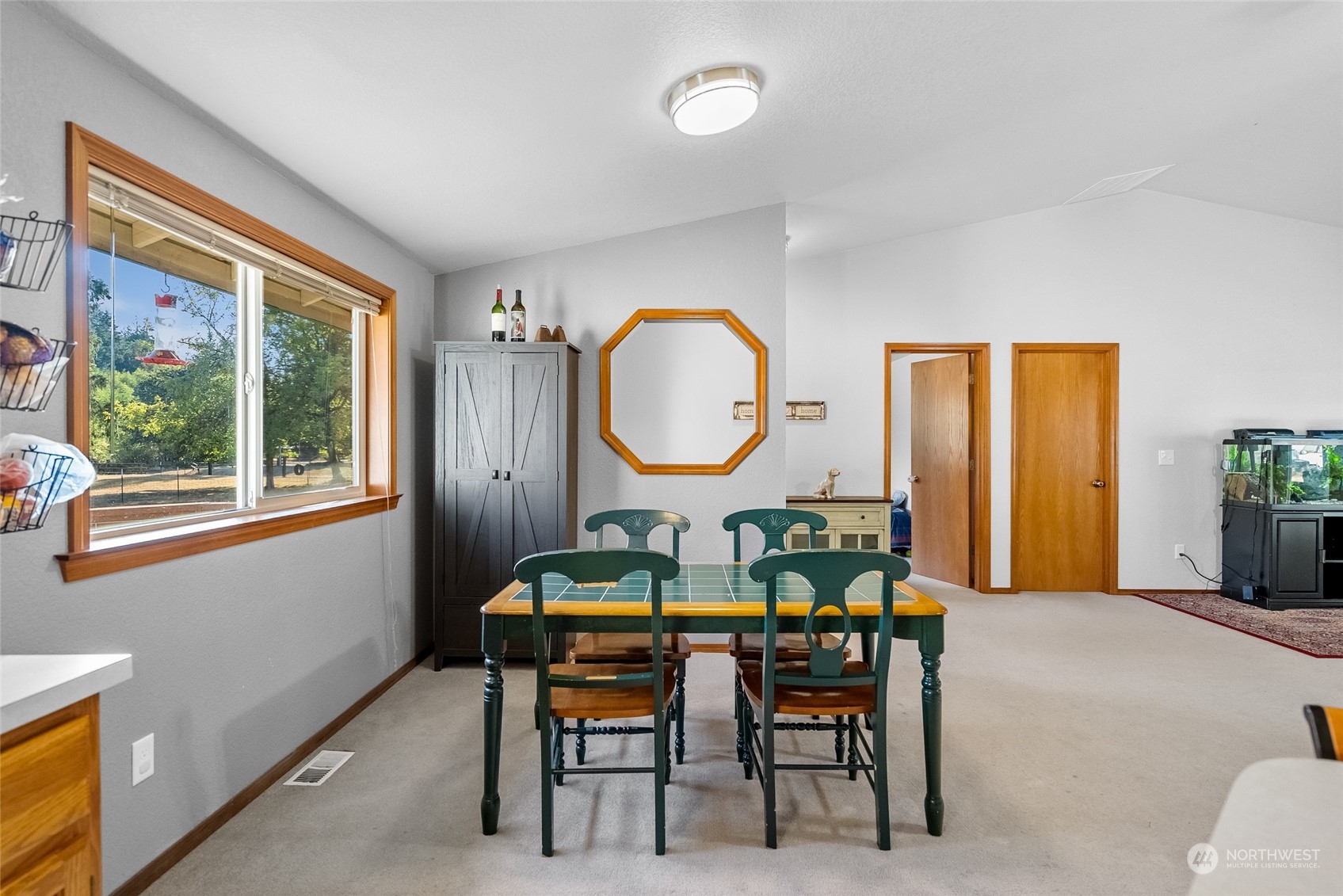 5520 133rd Avenue Southwest Rochester, WA 98579 - Photo 21 of 40 a view of a dining room with furniture window and wooden floor