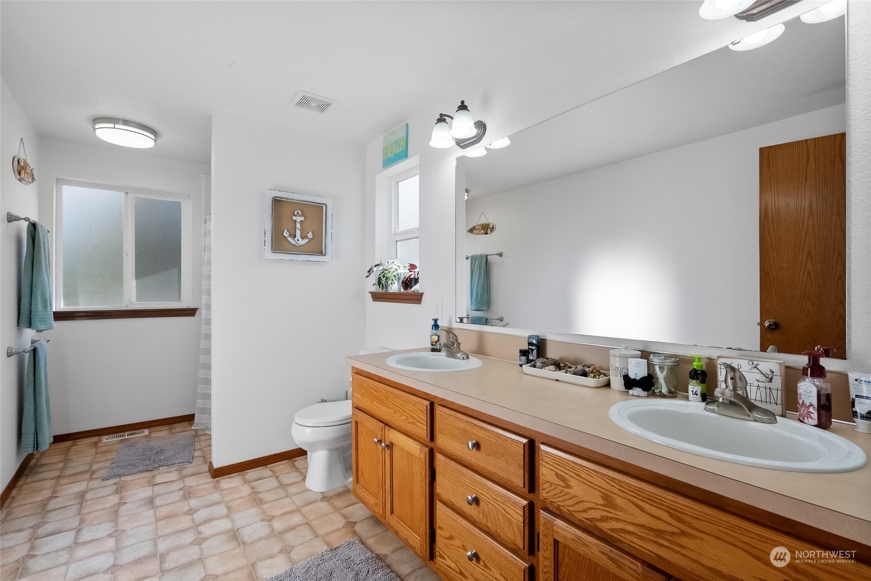 5520 133rd Avenue Southwest Rochester, WA 98579 - Photo 26 of 40 a bathroom with a double vanity sink mirror and toilet