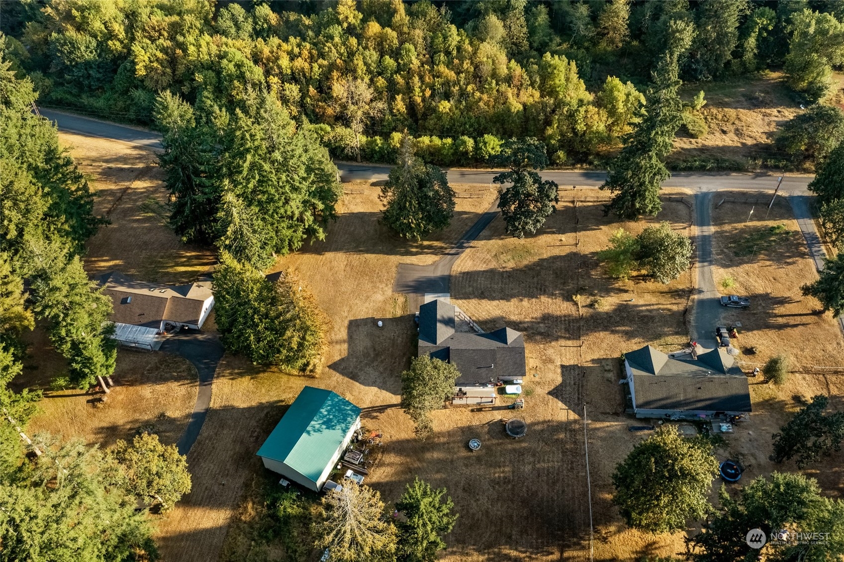 5520 133rd Avenue Southwest Rochester, WA 98579 - Photo 4 of 40 an aerial view of a house with a yard lake and trees all around