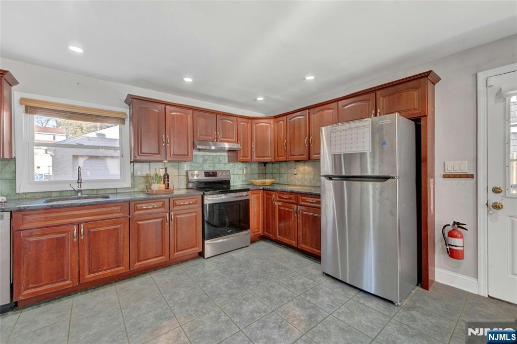 683 Eastern Court Ridgewood, NJ 07450 - Photo 11 of 25 a kitchen with stainless steel appliances granite countertop a refrigerator and a sink