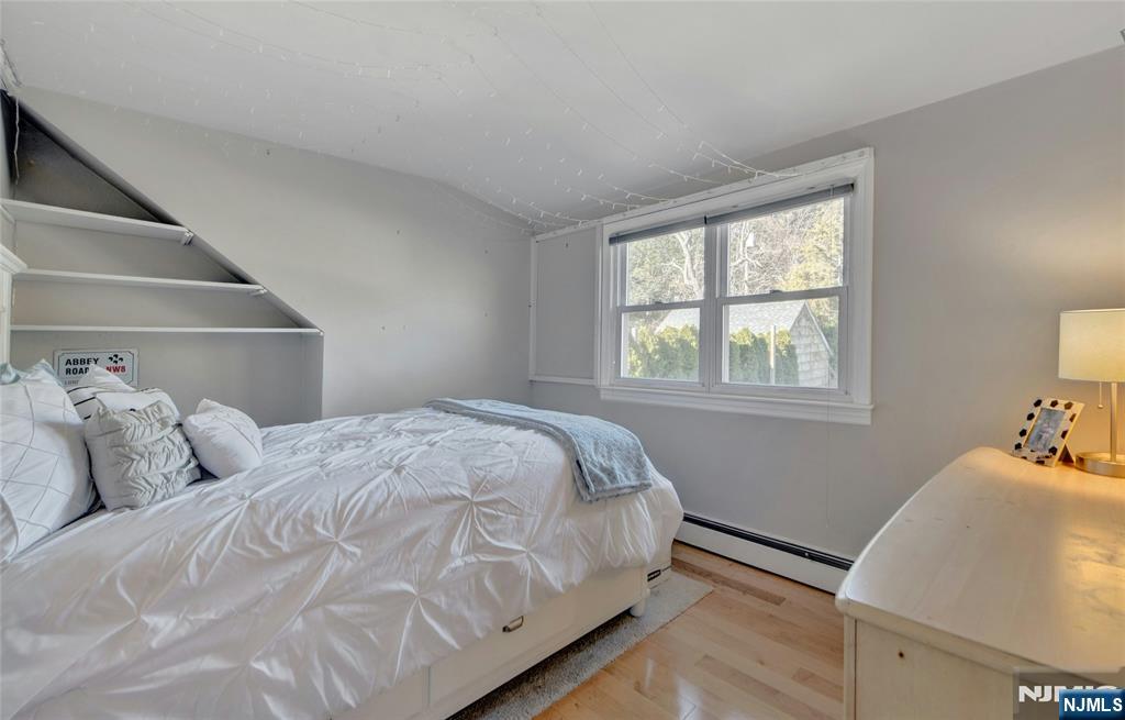 683 Eastern Court Ridgewood, NJ 07450 - Photo 17 of 25 a bedroom with a bed and wooden floor