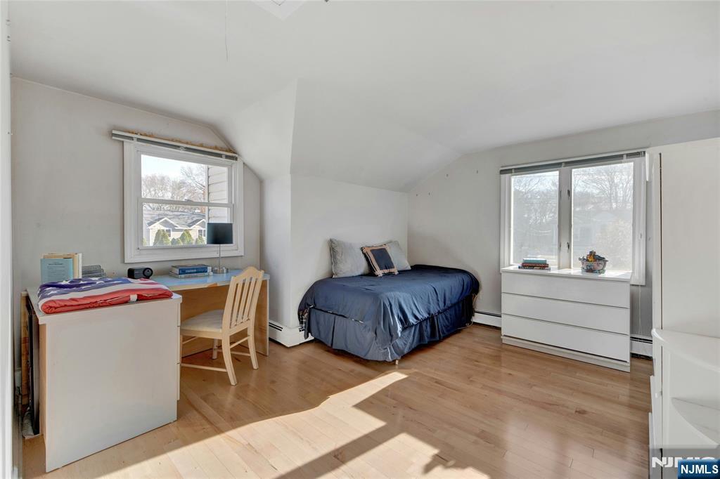 683 Eastern Court Ridgewood, NJ 07450 - Photo 20 of 25 a spacious bedroom with a bed and a table in it