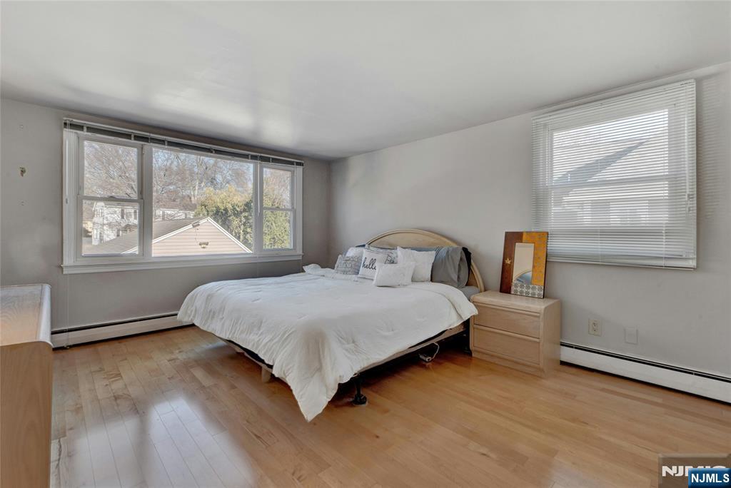 683 Eastern Court Ridgewood, NJ 07450 - Photo 21 of 25 a bedroom with a bed next to a window