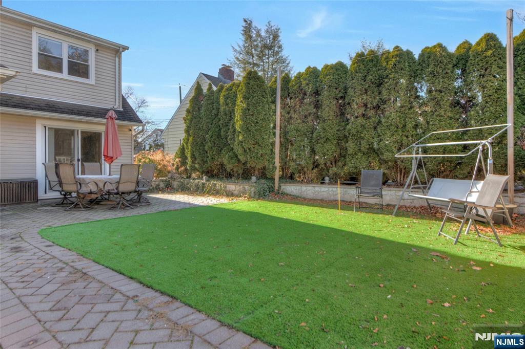 683 Eastern Court Ridgewood, NJ 07450 - Photo 25 of 25 a backyard of a house with table and chairs