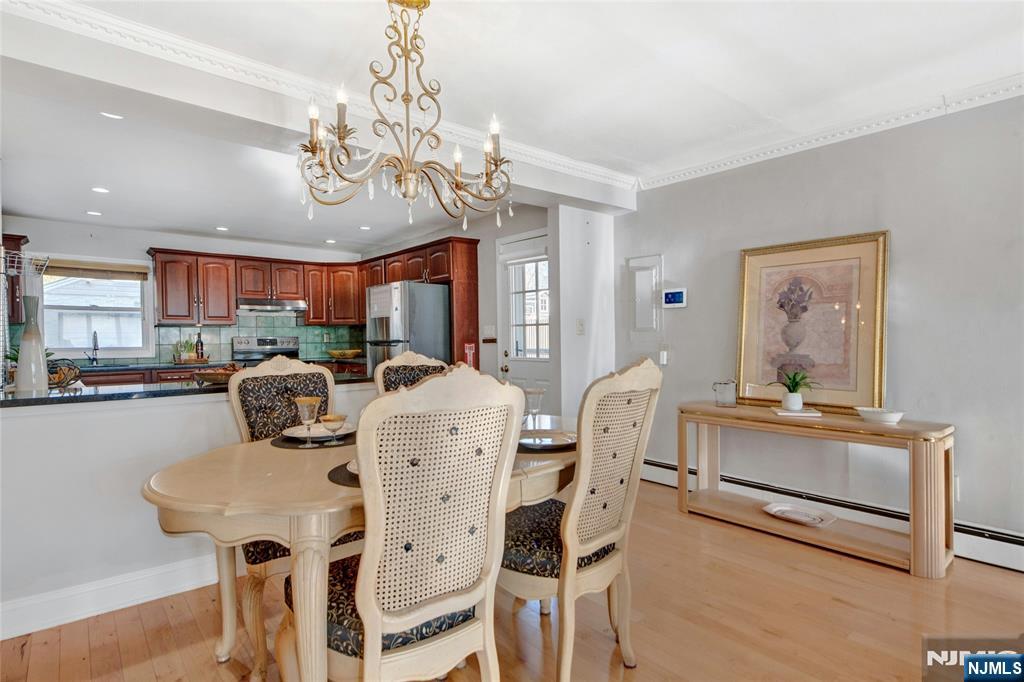 683 Eastern Court Ridgewood, NJ 07450 - Photo 6 of 25 a view of a dining room with furniture a chandelier and wooden floor