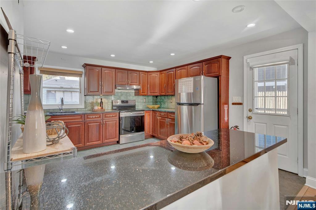 683 Eastern Court Ridgewood, NJ 07450 - Photo 10 of 25 a kitchen with stainless steel appliances granite countertop a refrigerator sink and stove