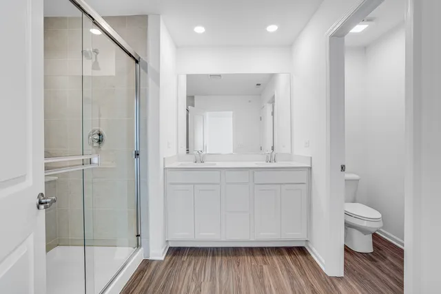 a bathroom with a sink a toilet and shower