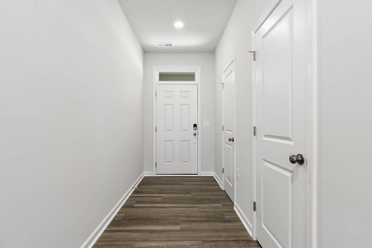2421 Chert Lane Raleigh, NC 27610 - Photo 11 of 97 a view of a hallway with wooden floor and staircase