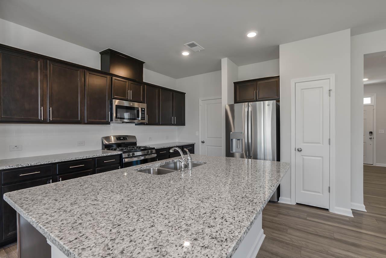 2421 Chert Lane Raleigh, NC 27610 - Photo 17 of 97 a kitchen with stainless steel appliances granite countertop a sink stove and refrigerator