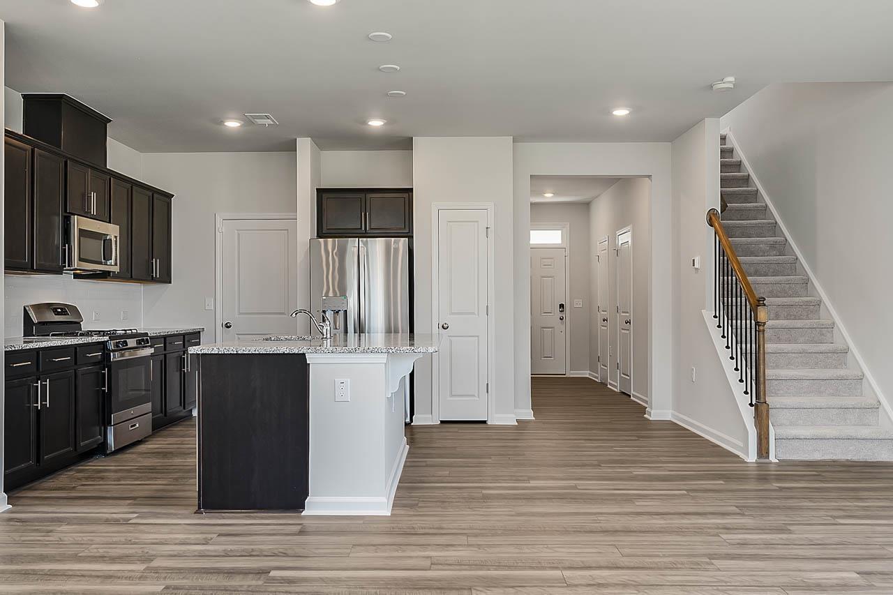 2421 Chert Lane Raleigh, NC 27610 - Photo 23 of 97 a large kitchen with stainless steel appliances granite countertop a stove and a refrigerator