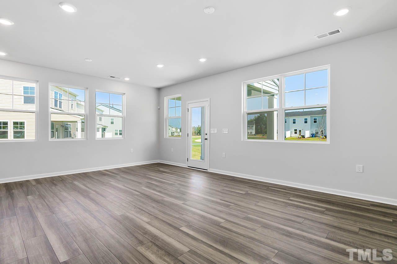 2421 Chert Lane Raleigh, NC 27610 - Photo 25 of 97 a view of an empty room with window and wooden floor