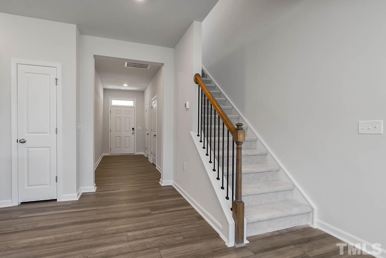 2421 Chert Lane Raleigh, NC 27610 - Photo 26 of 97 a view of a hallway with wooden floor and entryway