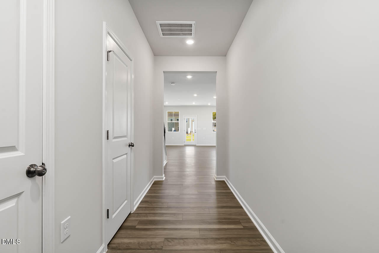 2421 Chert Lane Raleigh, NC 27610 - Photo 62 of 97 a view of a hallway with wooden floor and staircase
