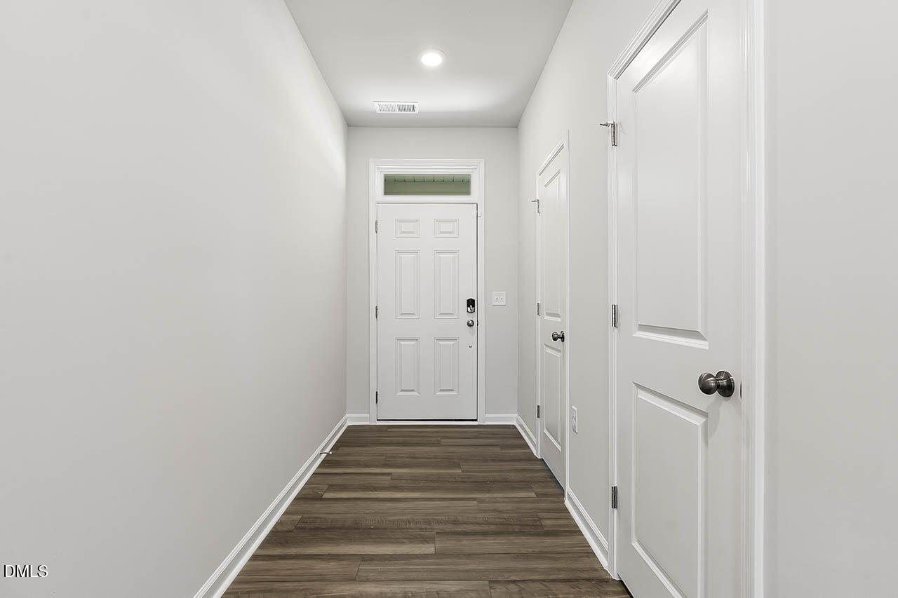 2421 Chert Lane Raleigh, NC 27610 - Photo 63 of 97 a view of a hallway with wooden floor and staircase