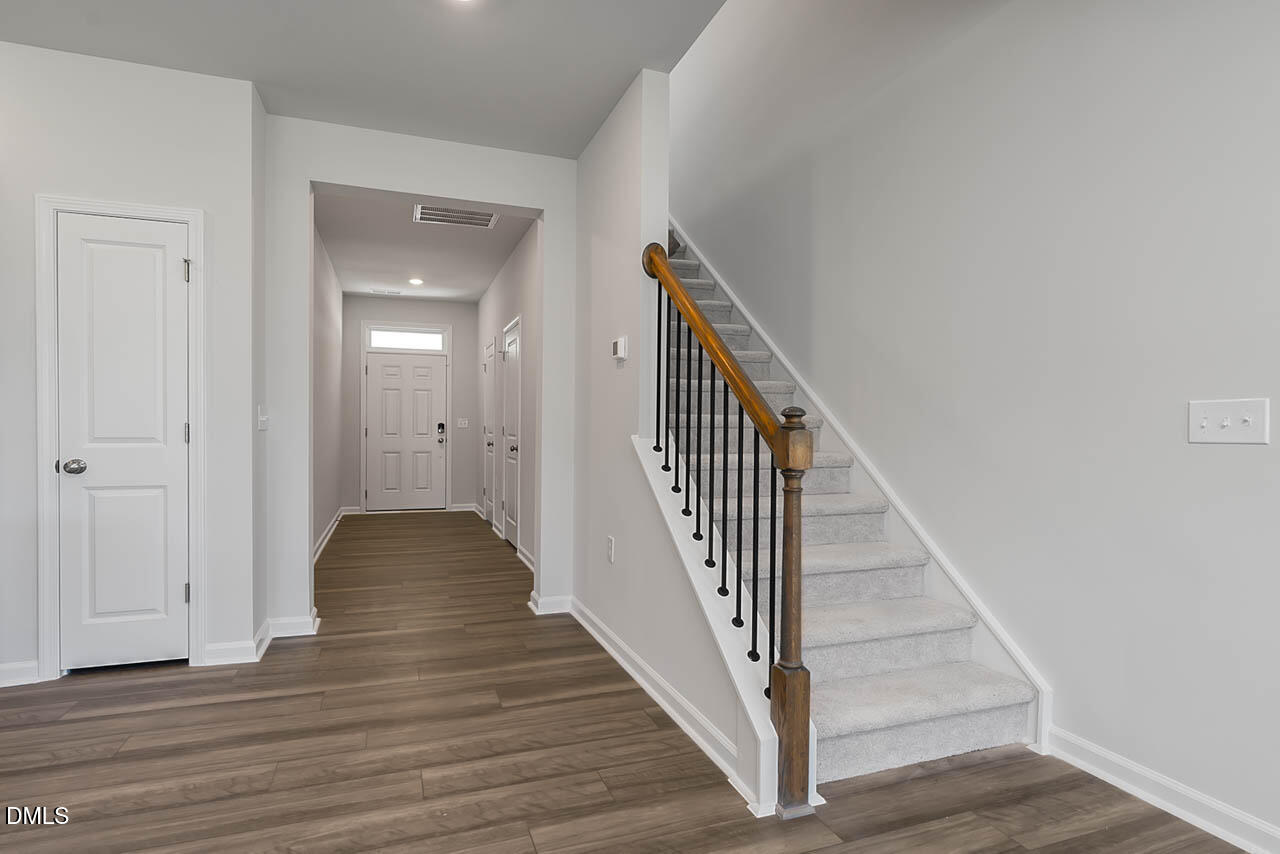 2421 Chert Lane Raleigh, NC 27610 - Photo 64 of 97 a view of a hallway with wooden floor and entryway