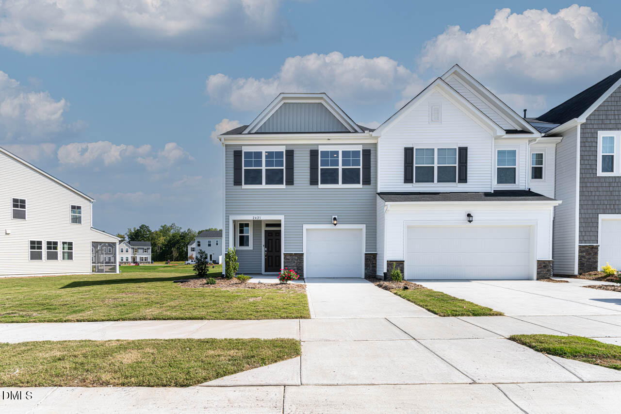 2421 Chert Lane Raleigh, NC 27610 - Photo 65 of 97 a front view of a house with a yard