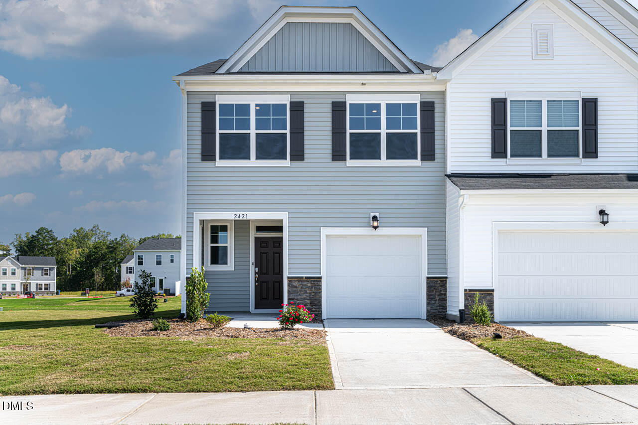 2421 Chert Lane Raleigh, NC 27610 - Photo 66 of 97 a front view of a house with a yard