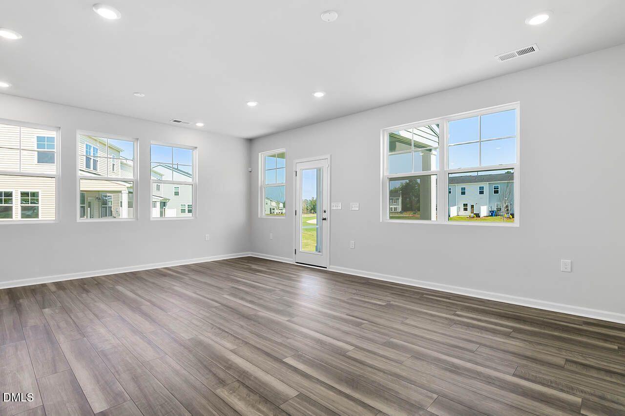 2421 Chert Lane Raleigh, NC 27610 - Photo 89 of 97 a view of an empty room with window and wooden floor