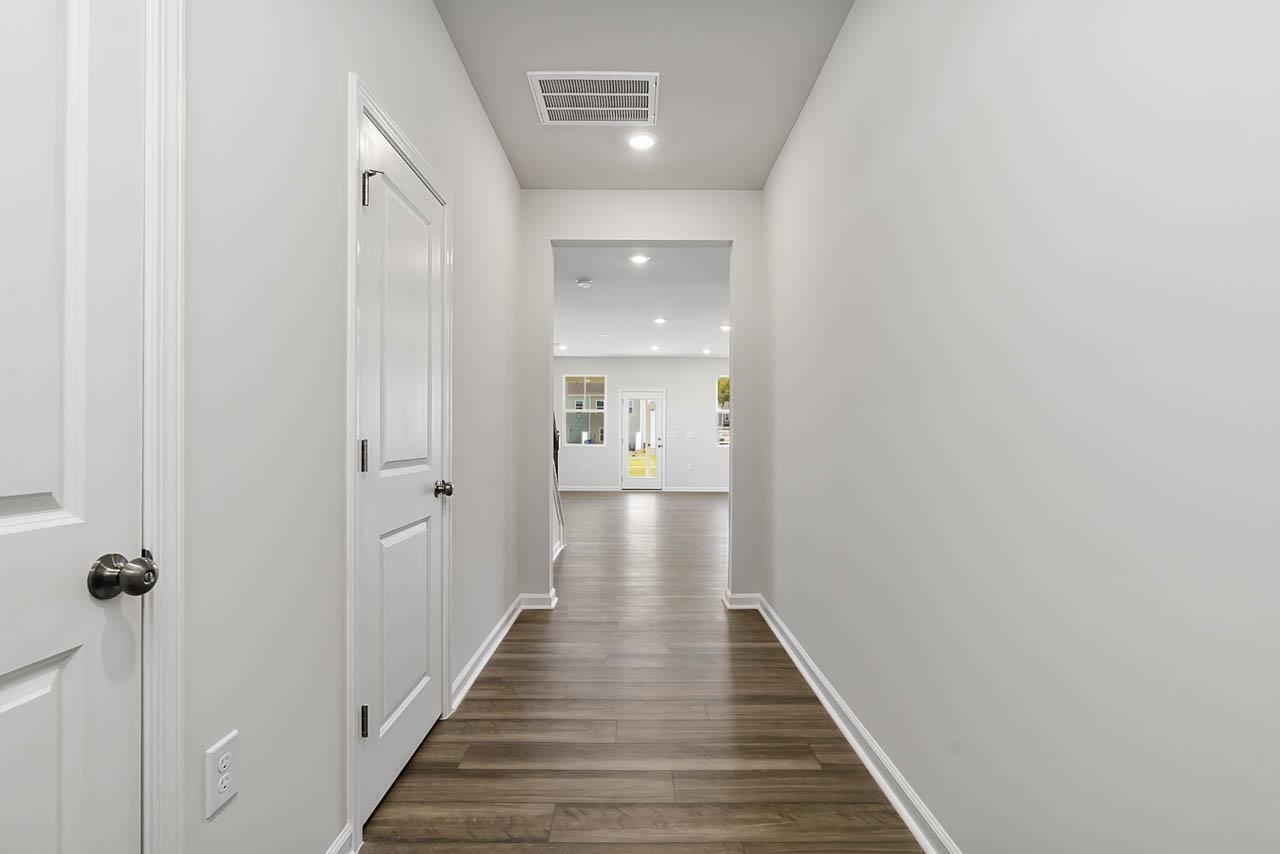 2421 Chert Lane Raleigh, NC 27610 - Photo 10 of 97 a view of a hallway with wooden floor and staircase