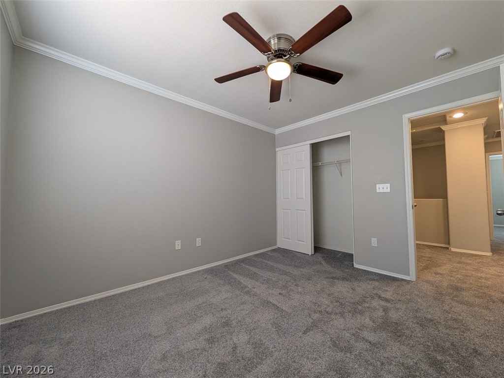 10308 Faustine Avenue Las Vegas, NV 89129 - Photo 20 of 28 A comfortable bedroom with plush carpeting and a modern ceiling fan, offering a serene personal space.