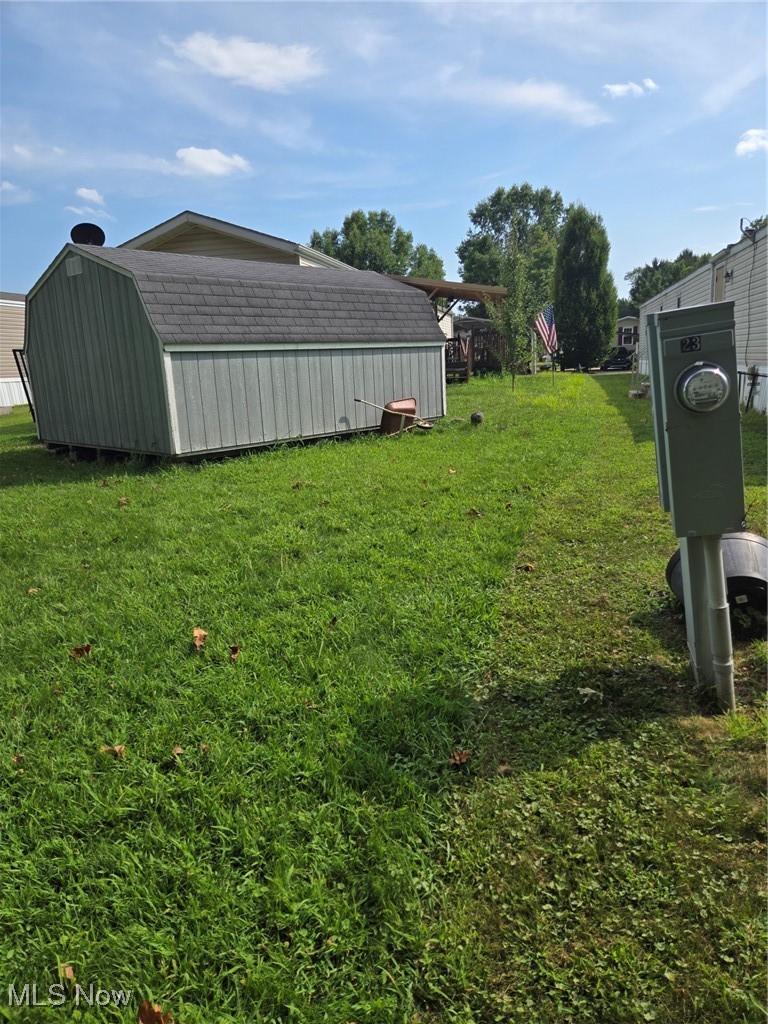 5974 Cleveland Road, Unit 23 Wooster, OH 44691 - Photo 25 of 29 View of grassy yard featuring an outbuilding