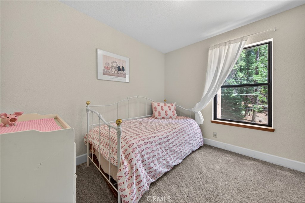 627 Cedar Canyon Road Lake Almanor, CA 96137 - Photo 13 of 34 a bedroom with a bed and a window