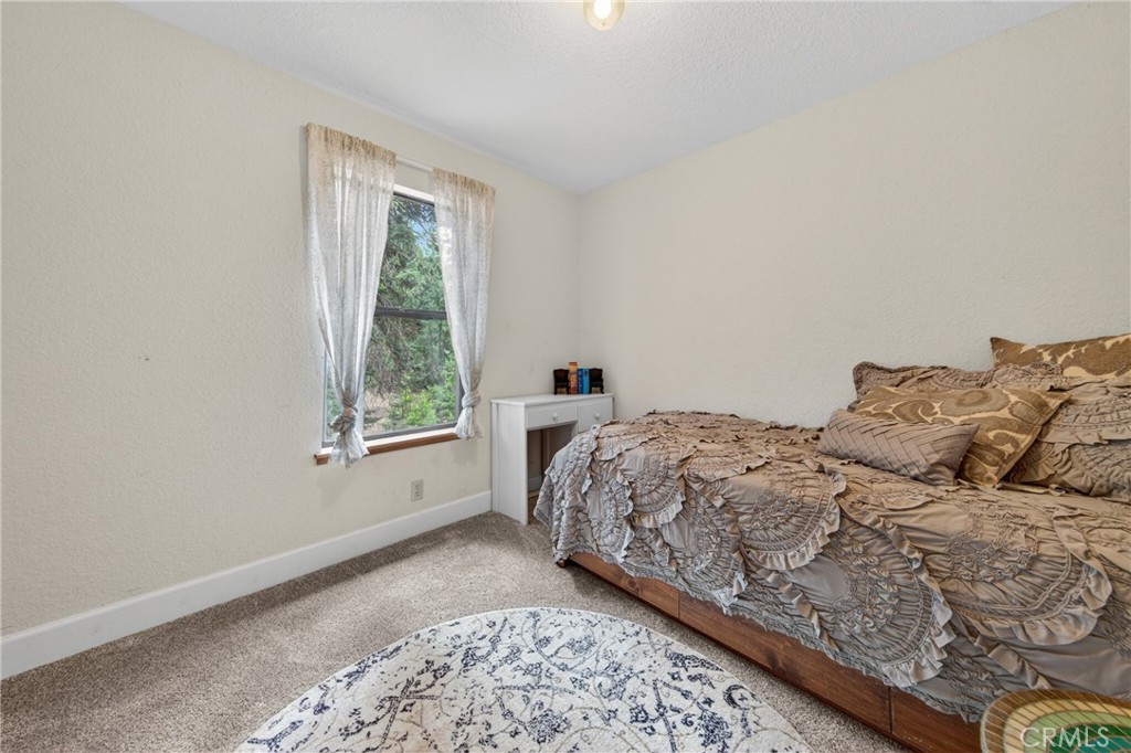 627 Cedar Canyon Road Lake Almanor, CA 96137 - Photo 15 of 34 a bedroom with a bed and a window