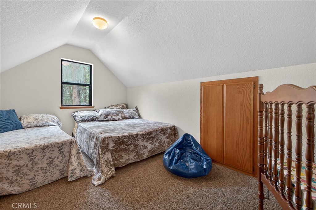 627 Cedar Canyon Road Lake Almanor, CA 96137 - Photo 21 of 34 a bedroom with bed and a window