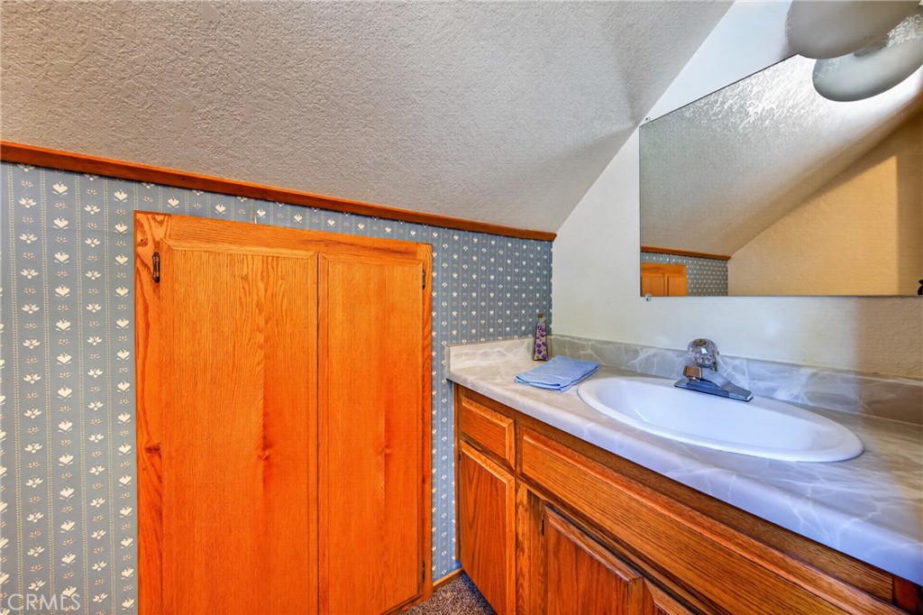 627 Cedar Canyon Road Lake Almanor, CA 96137 - Photo 25 of 34 a bathroom with a sink and a mirror