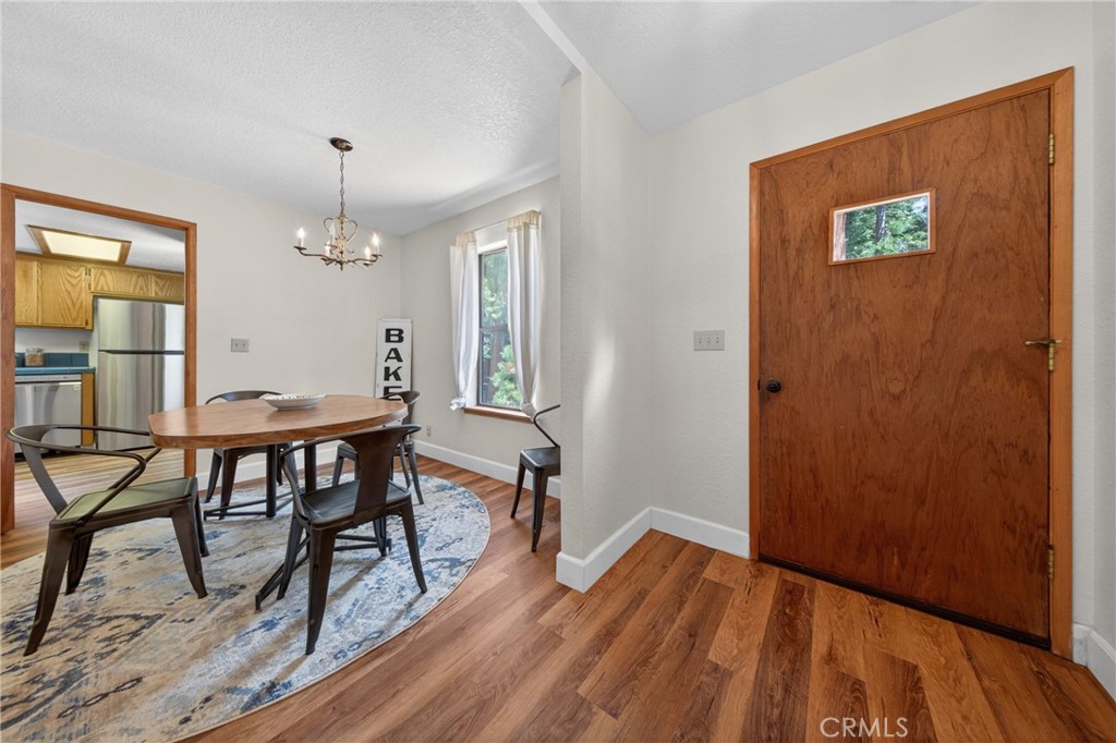 627 Cedar Canyon Road Lake Almanor, CA 96137 - Photo 5 of 34 a view of a dining room with furniture and wooden floor