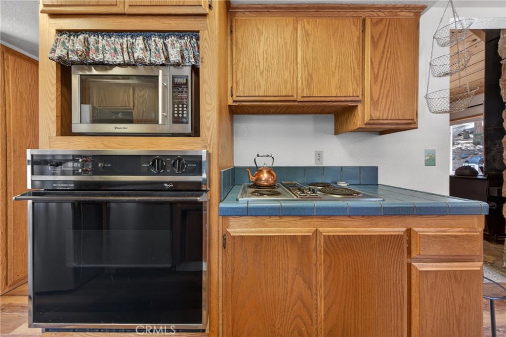 627 Cedar Canyon Road Lake Almanor, CA 96137 - Photo 8 of 34 a kitchen with granite countertop a stove and a microwave