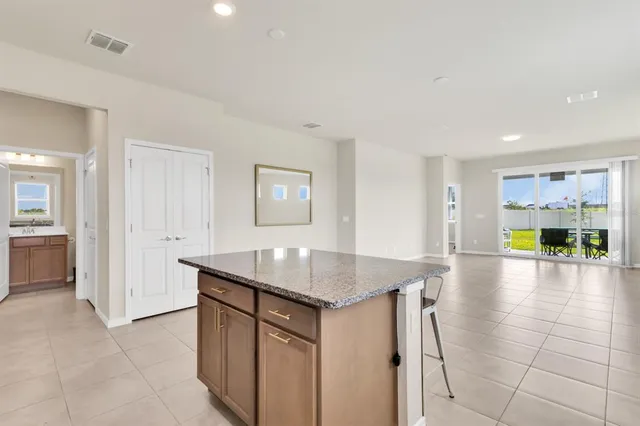 a kitchen with stainless steel appliances granite countertop a sink and a refrigerator