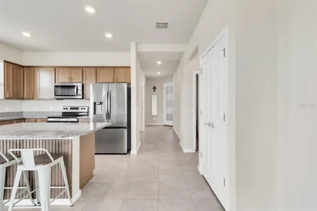 a kitchen with stainless steel appliances a refrigerator and a stove top oven