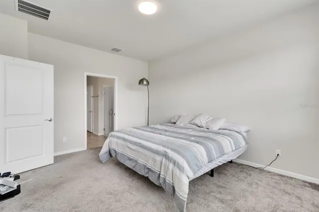 a bedroom with a bed and a closet