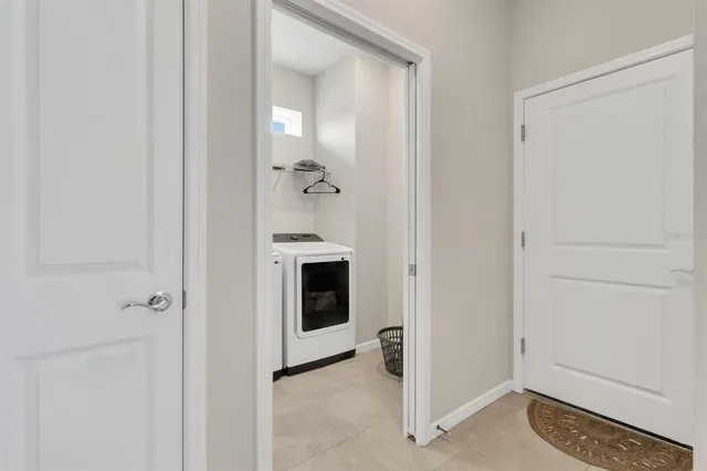 a view of a hallway with closet and a refrigerator