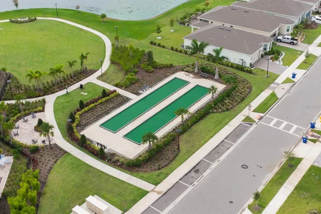 an aerial view of a house with a garden and swimming pool