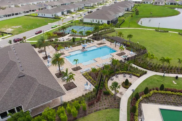 an aerial view of a house a yard and outdoor seating