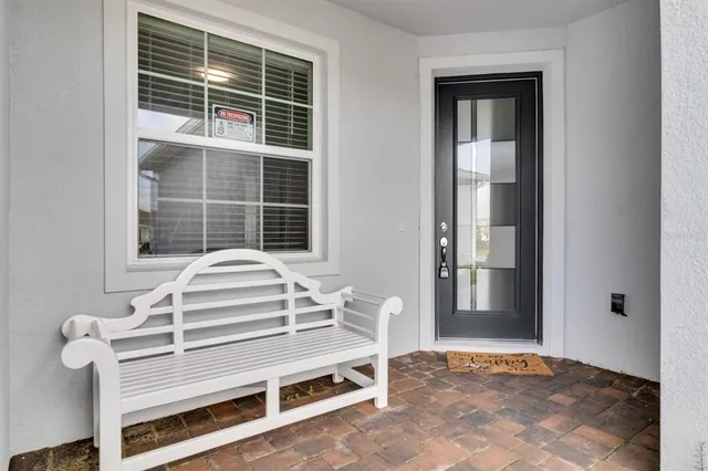 a view of a bedroom with wooden floor and windows