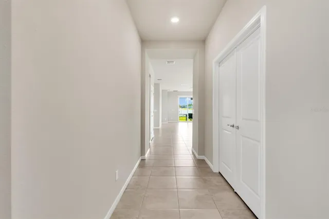 a view of a hallway with wooden shelves