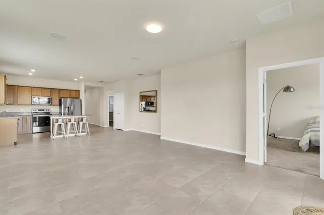 a view of a living room and kitchen with furniture and a flat screen tv