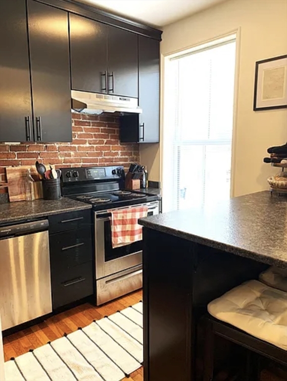 167 I Street, Unit 2 Boston, MA 02127 - Photo 5 of 9 a kitchen with stainless steel appliances granite countertop a stove a sink and a refrigerator
