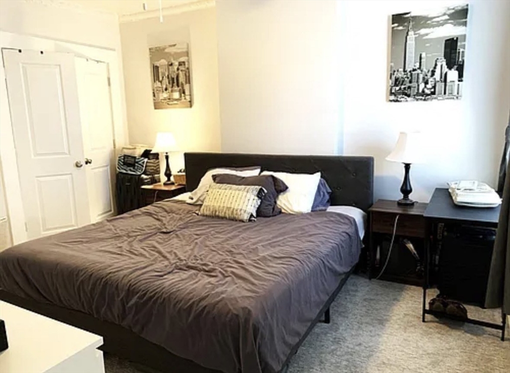 167 I Street, Unit 2 Boston, MA 02127 - Photo 6 of 9 a bedroom with a bed and wooden floor