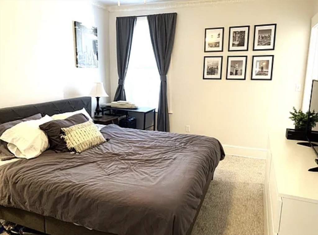 167 I Street, Unit 2 Boston, MA 02127 - Photo 7 of 9 a bedroom with a bed and a window