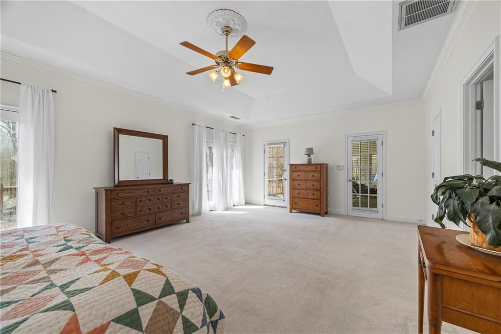 750 Staghorn Trail Nicholson, GA 30565 - Photo 11 of 41 a bedroom with a bed and a chandelier